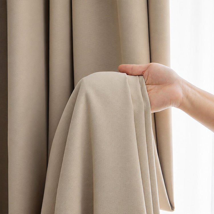 Close-up of thick beige cotton linen curtain fabric in vertical folds