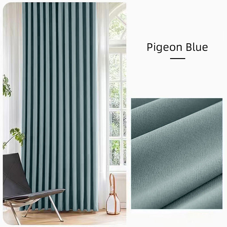 Pigeon blue cotton linen curtains beside a window with greenery